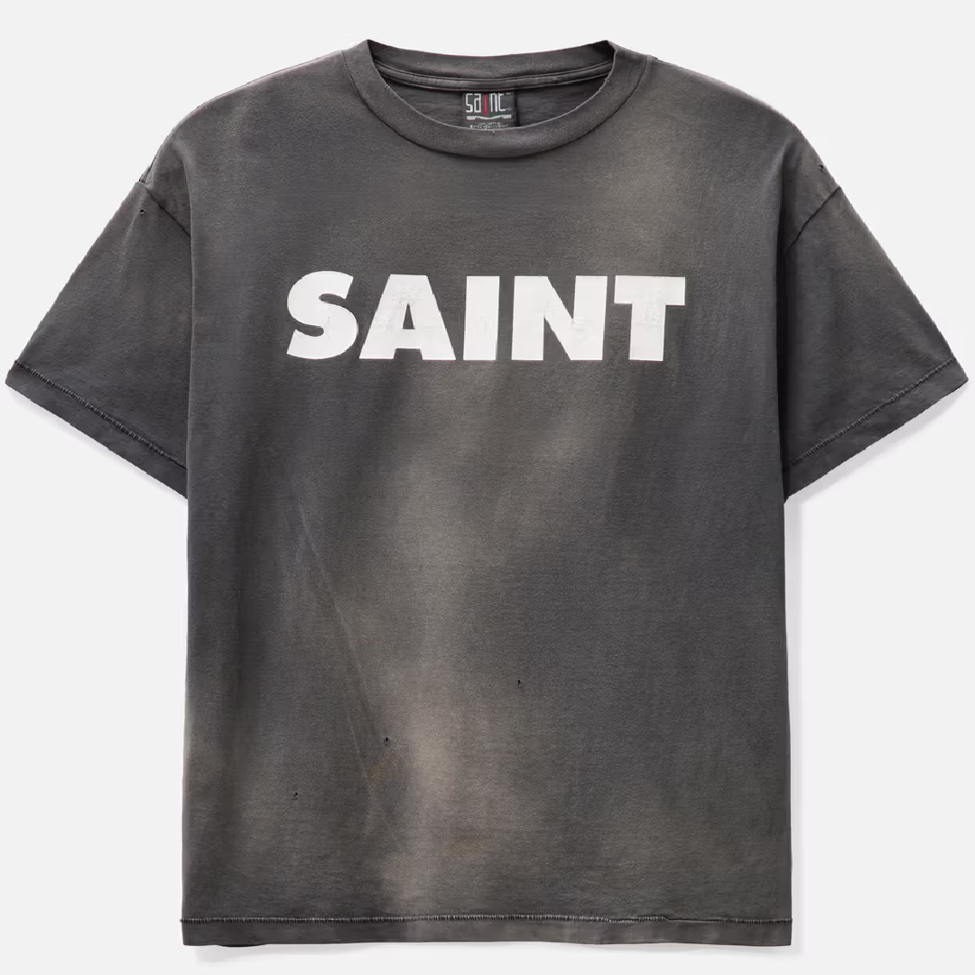 SAINT Mxxxxxx SNT Print T-Shirt – Graphic Design front SAINT Mxxxxxx S>N>T T-Shirt - Image 1
